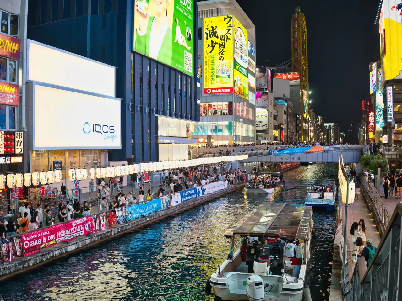Busy Namba and Shinsaibashi street in Osaka Japan lit up with bars and shops at night