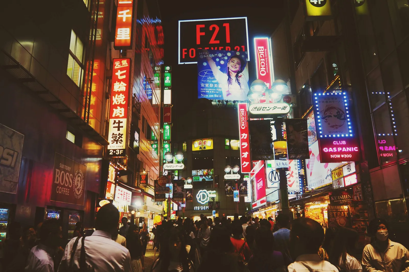 Neon signs and crowds along a Tokyo street at night