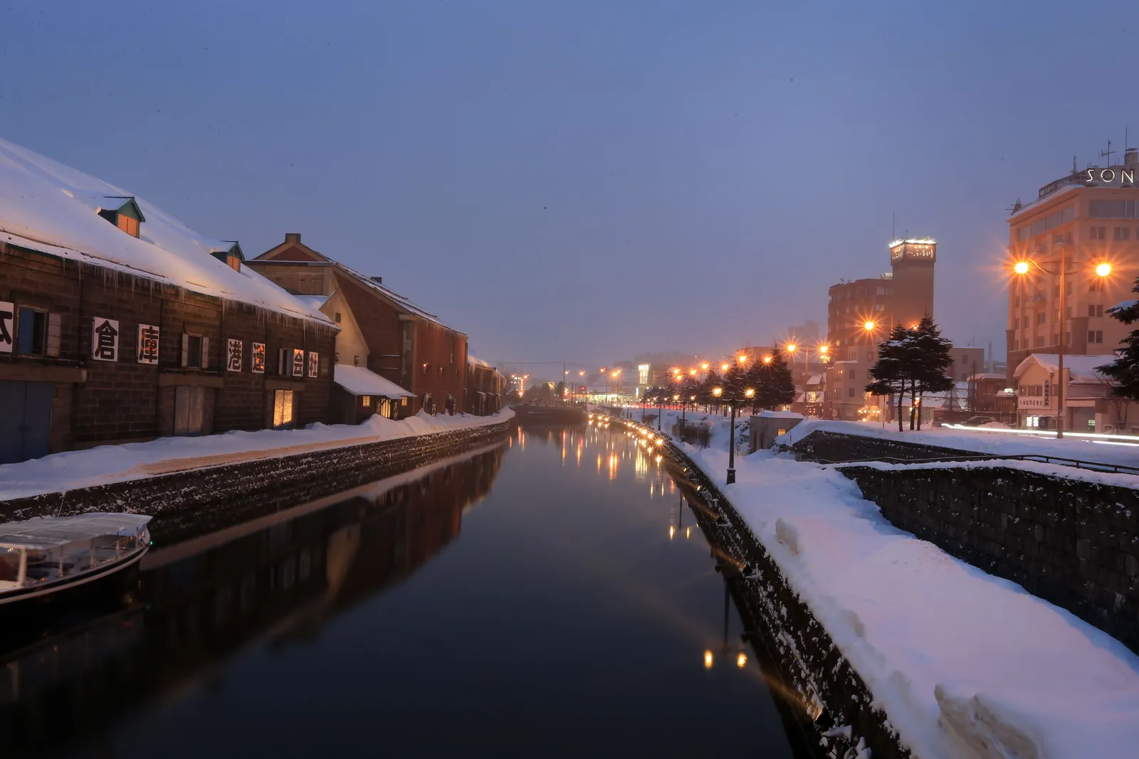 The canal and old stone warehouses of Otaru in Hokkaido lit up in the evening