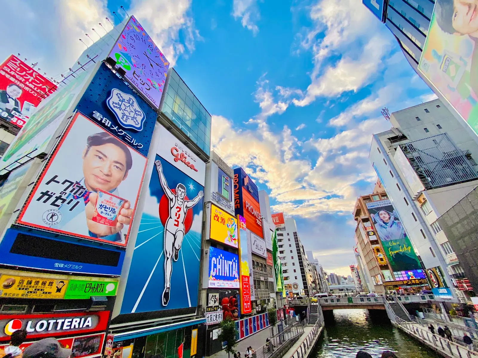 Dotonbori canal in Osaka Japan lit by neon signs and reflections at night