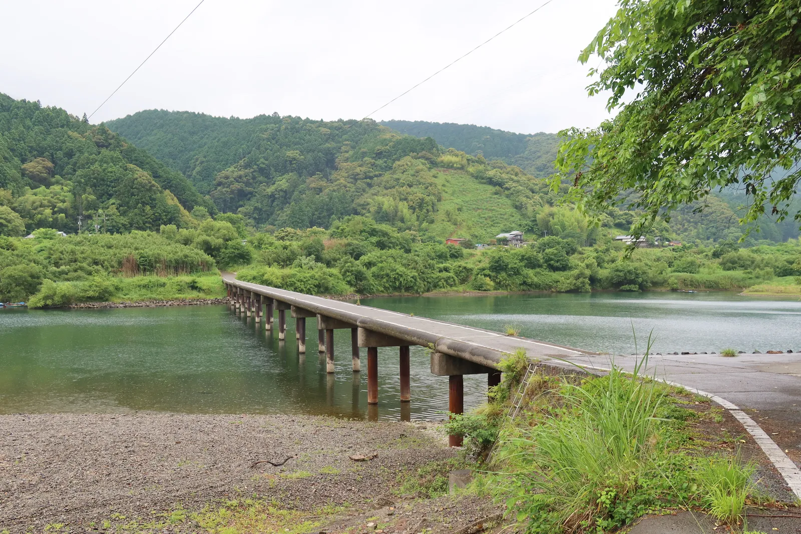 A long low wooden bridge without railings crossing a river in Kochi prefecture on Shikoku