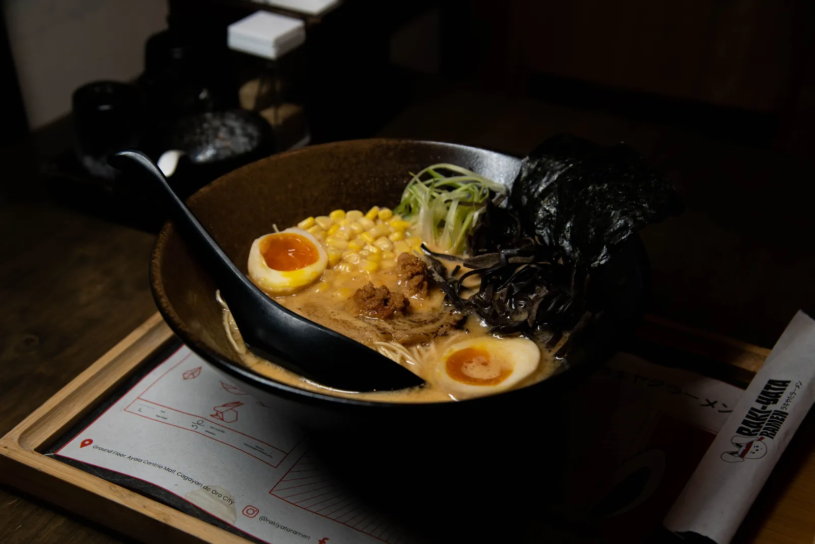 Steam rising from bowls of Sapporo miso ramen at a counter restaurant
