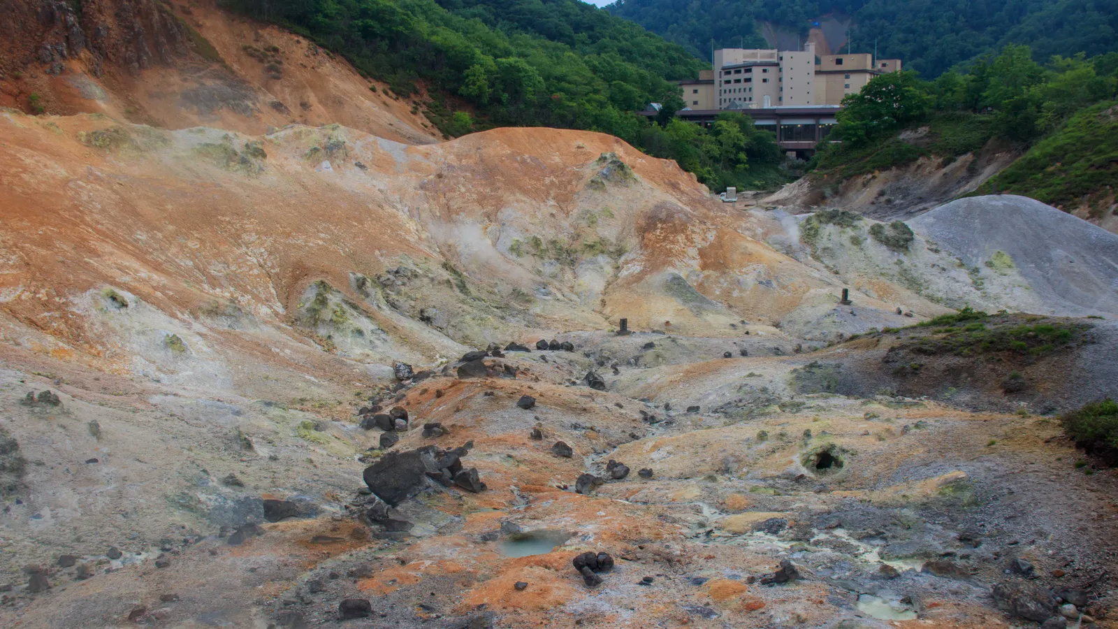 Steam rising from the volcanic vents of Jigokudani hell valley near Noboribetsu
