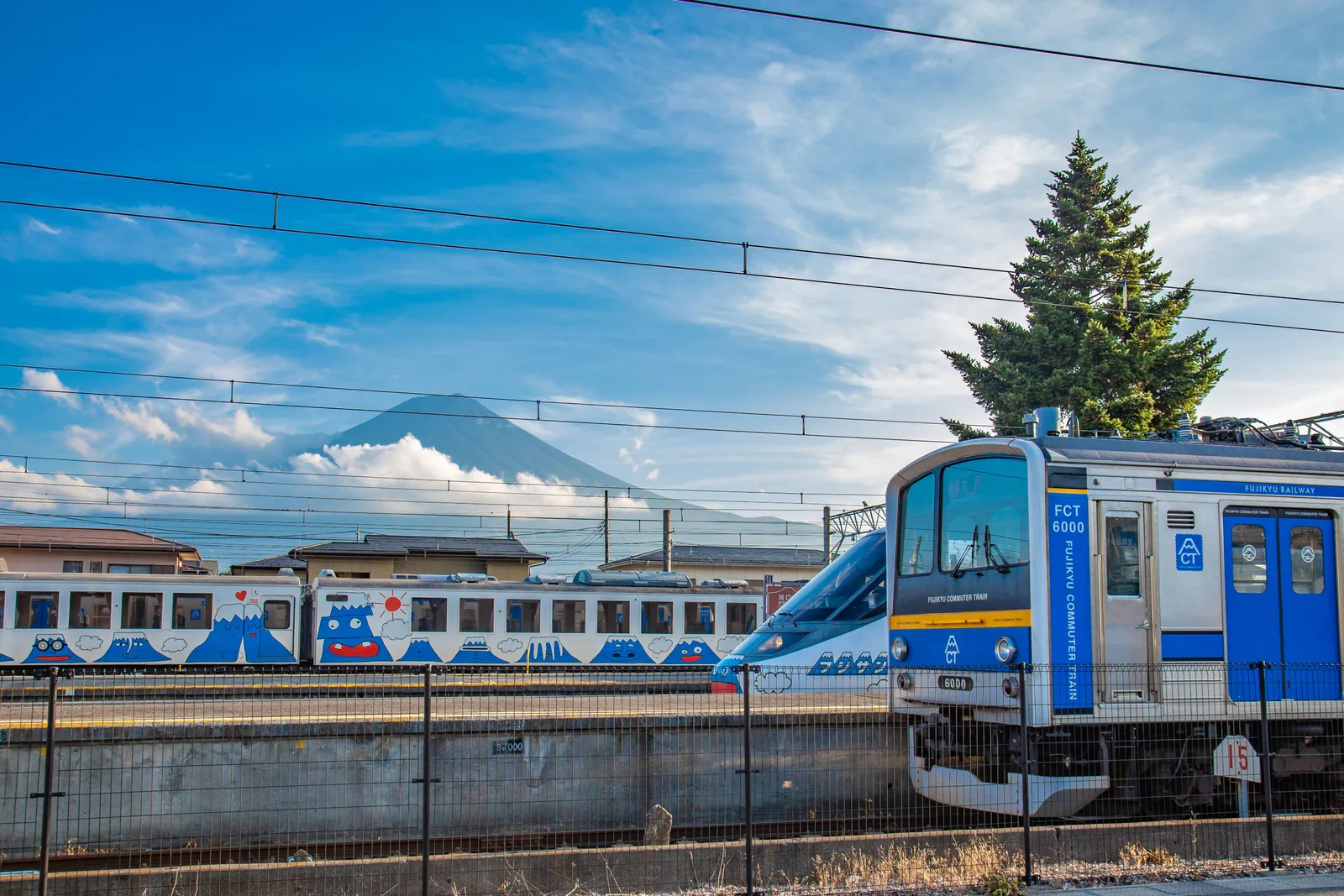 A shinkansen train passing through the Japanese countryside with Mount Fuji visible in the distance, Japan