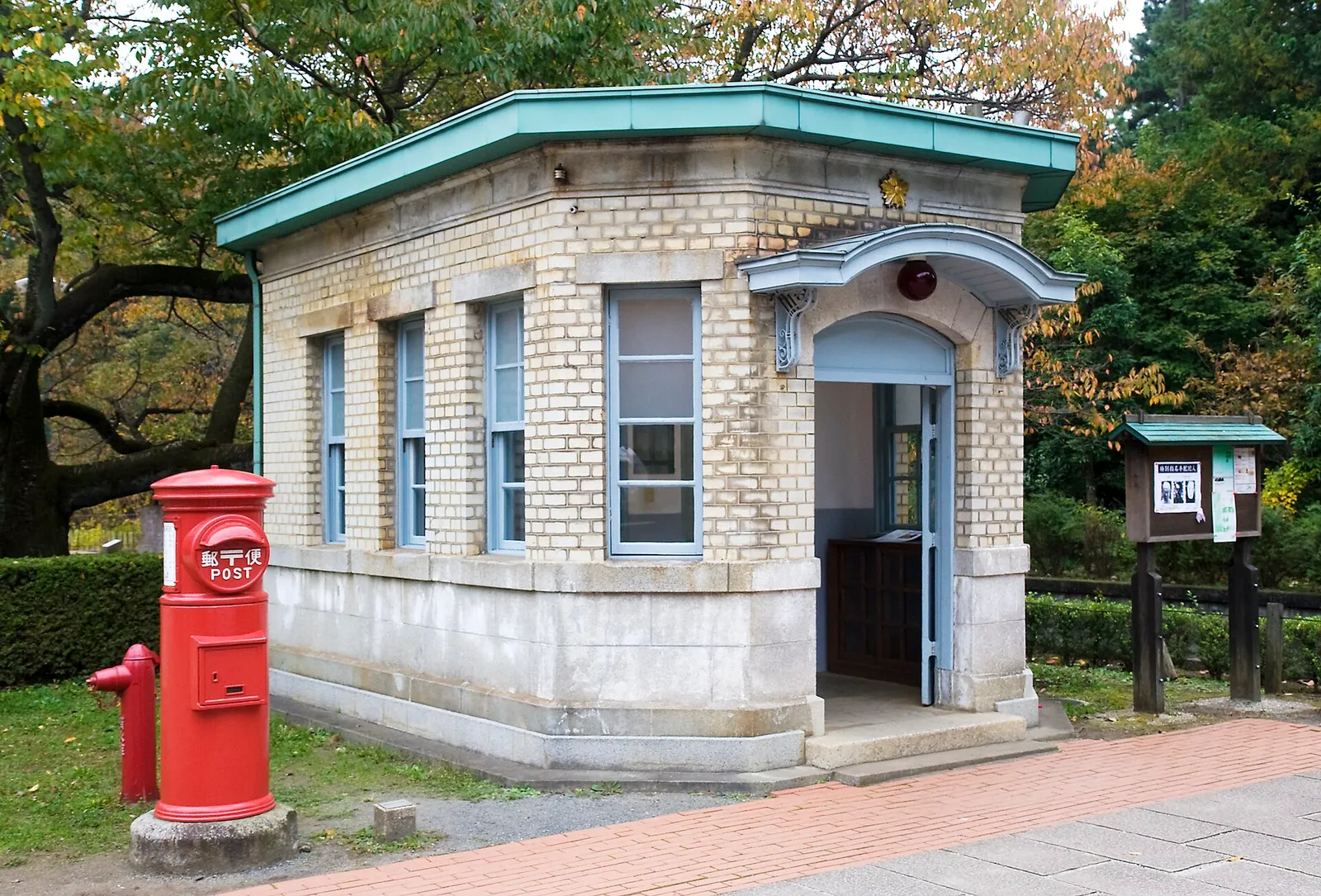 A small neighborhood koban police box on a street corner in Japan in daylight