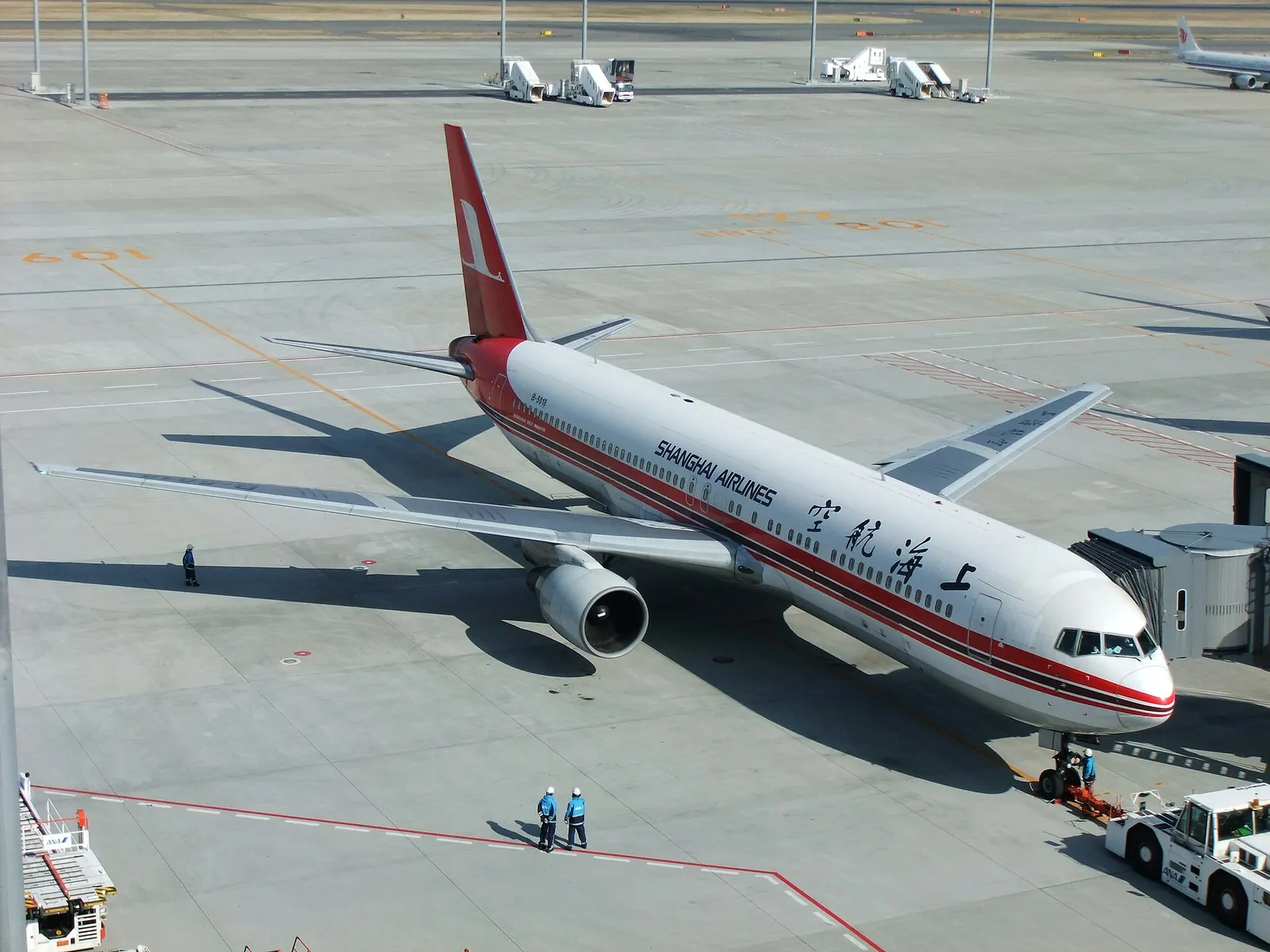 A passenger jet at Tokyo Haneda airport on a clear day, the start of a long-haul trip to Japan