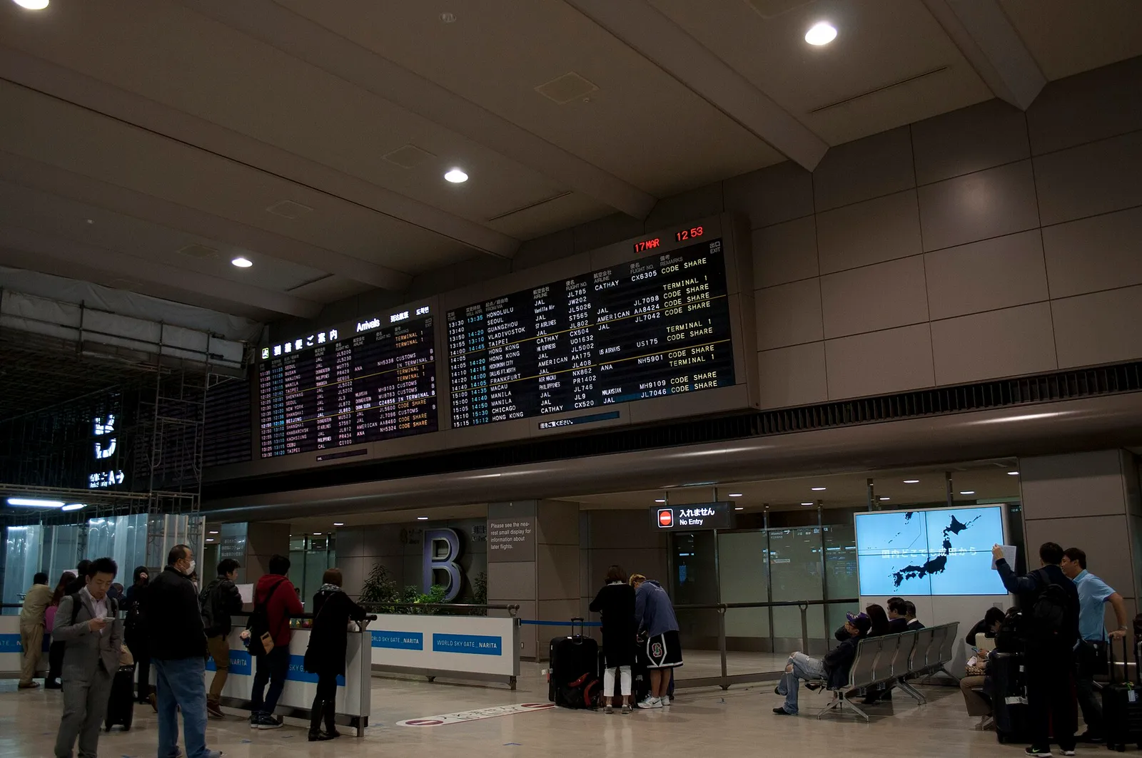 Travelers walking out of the arrival gate at Narita International Airport Terminal 2 in Japan
