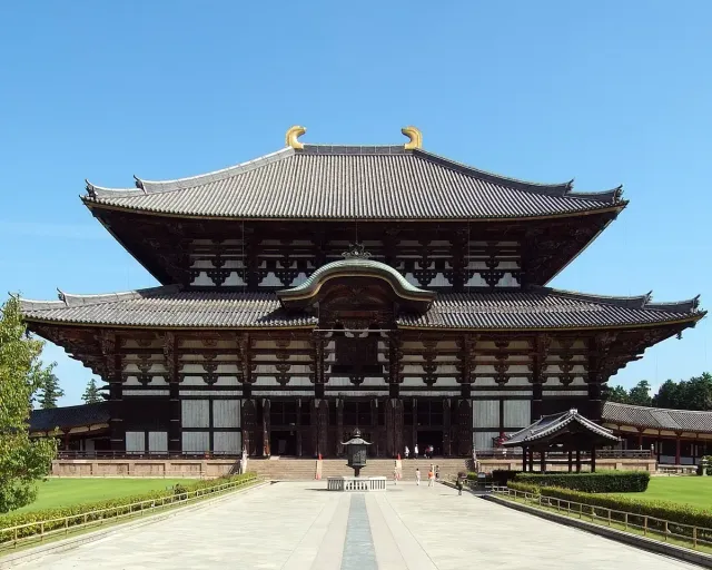 A huge wooden temple hall with a two-tiered roof