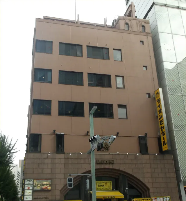 A building façade with signs at street level