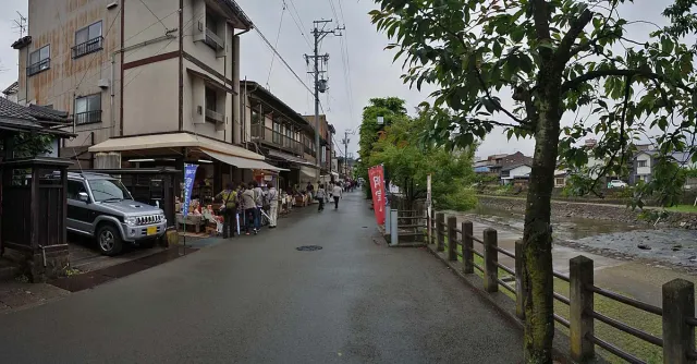 A market street beside a canal with stalls and visitors