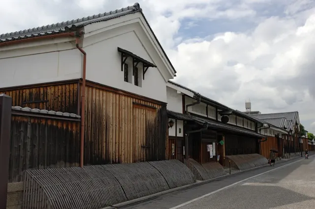 A street of traditional warehouses with white walls and tiled roofs