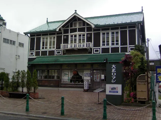 A two-storey wooden restaurant building with wide windows