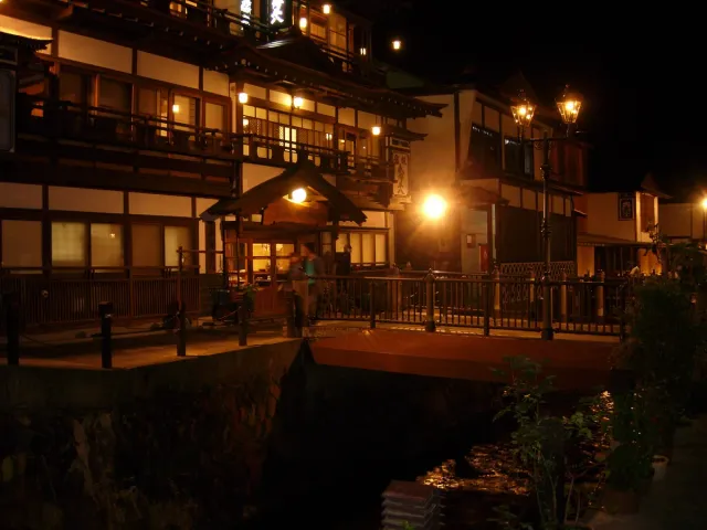 Three-storey wooden inns lit up in the evening