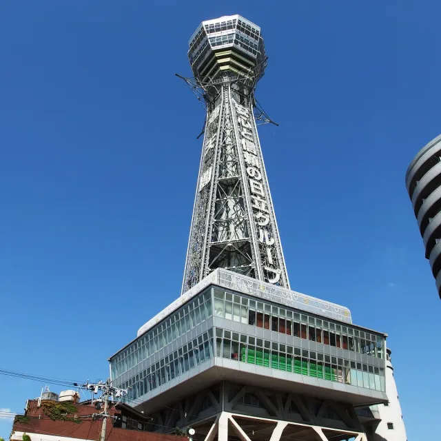 A steel lattice observation tower seen from below against a blue sky
