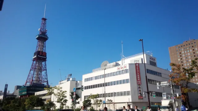 A steel lattice tower above city buildings