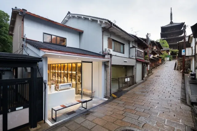 A small café on a paved street, with a pagoda visible up the road