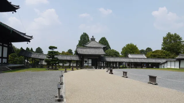 Low temple buildings around a wide gravel courtyard