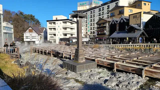 Wooden channels carrying steaming hot water through the town centre