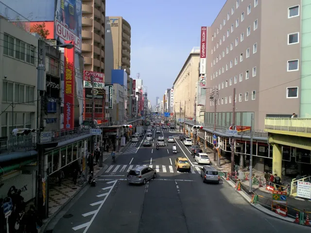 A wide main street lined with shop signs on both sides