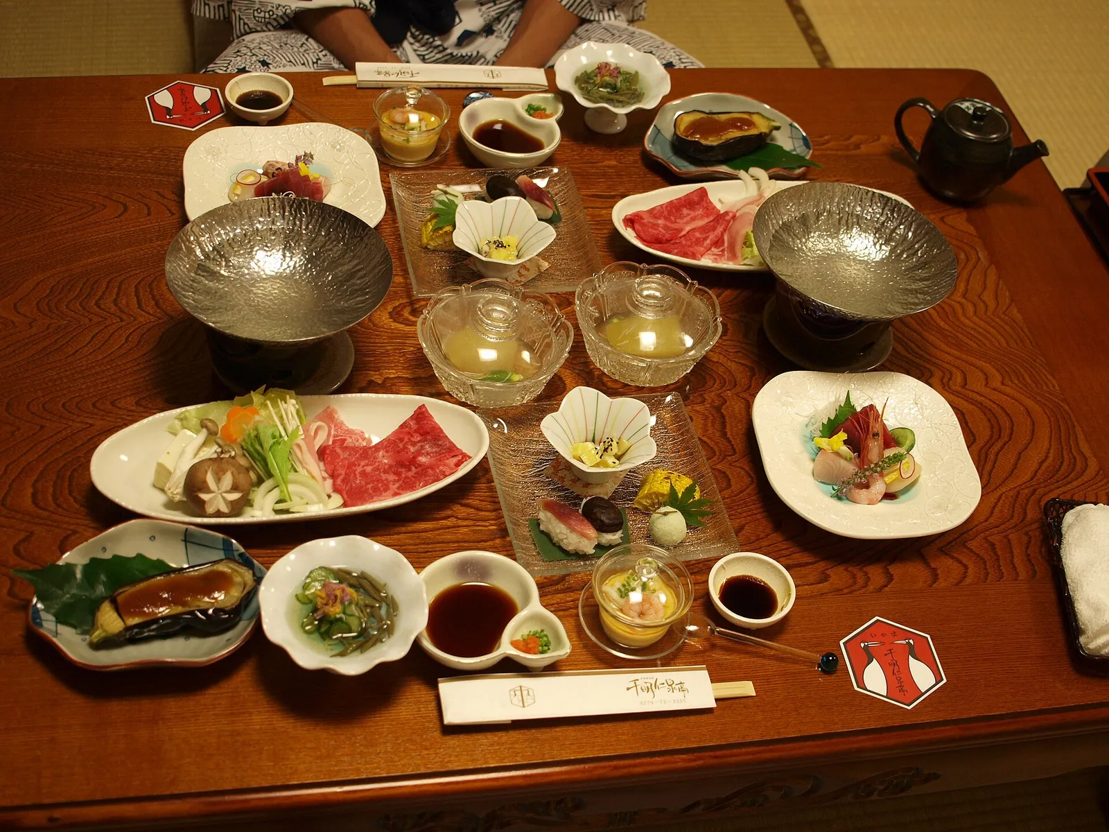A tray of small seasonal dishes set on a low table in a ryokan, Japan