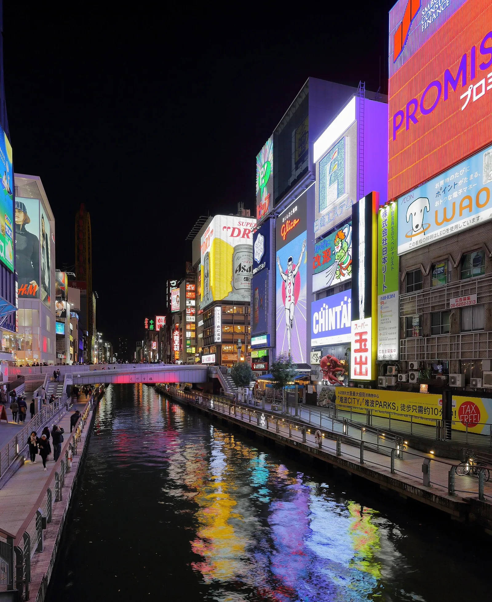 The neon signs of Dotonbori reflected in the canal at night, the heart of Osaka's food and nightlife district